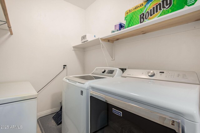 clothes washing area with laundry area and washing machine and clothes dryer