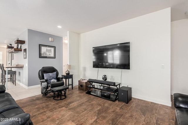 living area with baseboards, wood finished floors, and recessed lighting