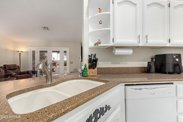 kitchen featuring white cabinets, light stone countertops, sink, and dishwasher