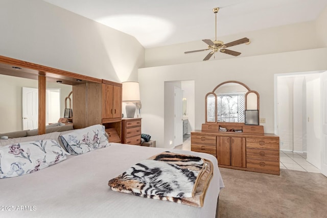 bedroom with ceiling fan, high vaulted ceiling, and light carpet