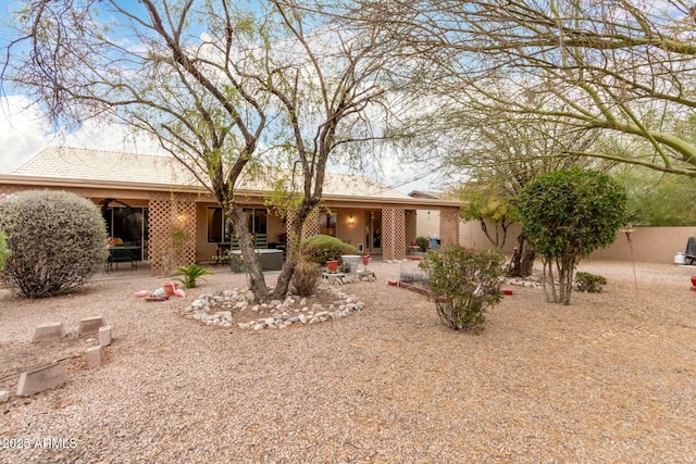 back of property with a patio