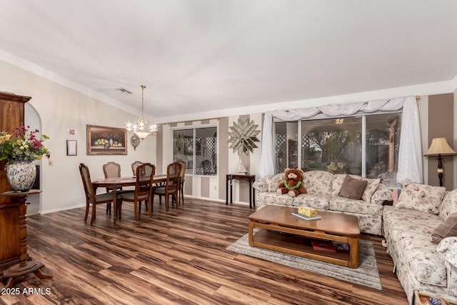 living room with a notable chandelier, vaulted ceiling, and dark hardwood / wood-style floors