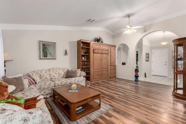 living room featuring ceiling fan, vaulted ceiling, and hardwood / wood-style floors