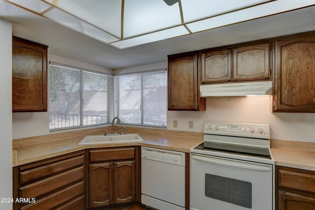 kitchen featuring sink and white appliances