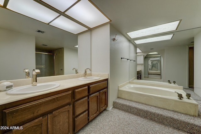 bathroom featuring vanity and a tub