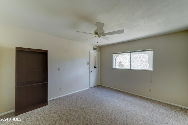 spare room featuring carpet flooring and ceiling fan