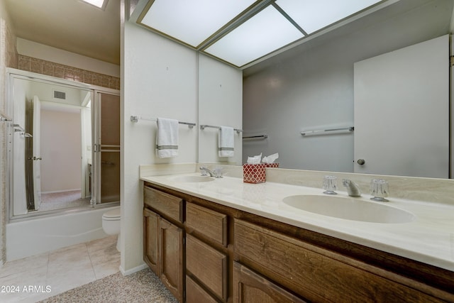 full bathroom featuring tile patterned flooring, vanity, toilet, and enclosed tub / shower combo