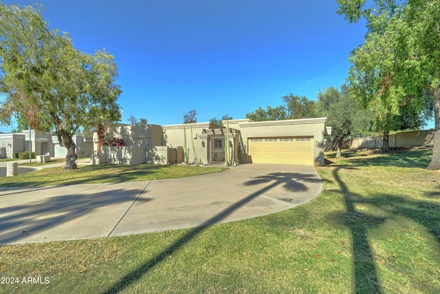 view of front of house with a garage and a front lawn