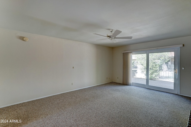 spare room featuring ceiling fan and carpet