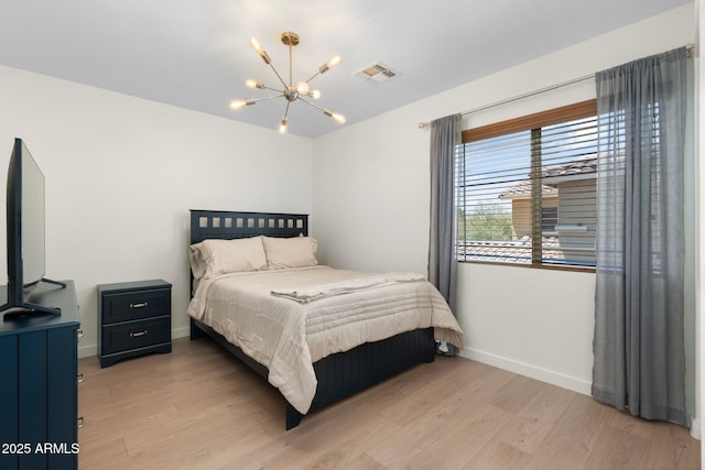 4960 E Colonial Dr, Chandler, AZ 85249 - bedroom with a chandelier, baseboards, and light wood-style flooring