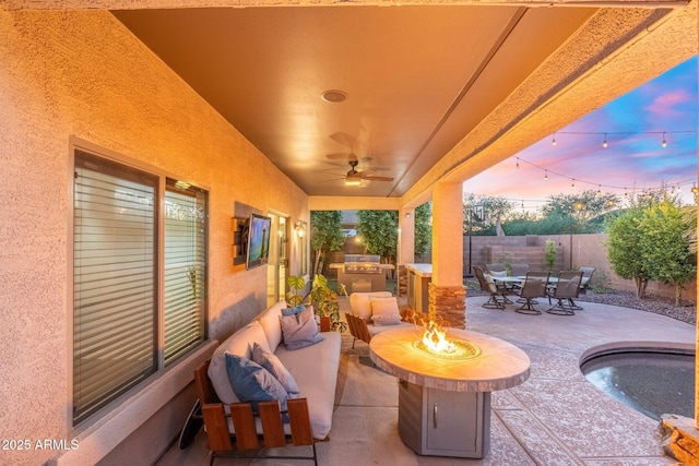 4960 E Colonial Dr, Chandler, AZ 85249 - patio terrace at dusk with outdoor dining area, area for grilling, a fenced backyard, a patio area, and ceiling fan