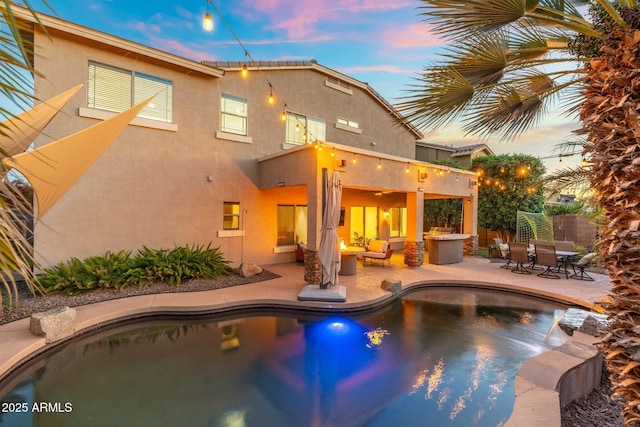 4960 E Colonial Dr, Chandler, AZ 85249 - pool at dusk featuring a patio, an outdoor pool, and an outdoor hangout area