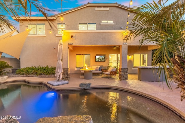 4960 E Colonial Dr, Chandler, AZ 85249 - back of house featuring stucco siding, an outdoor living space with a fire pit, a patio, and an outdoor pool
