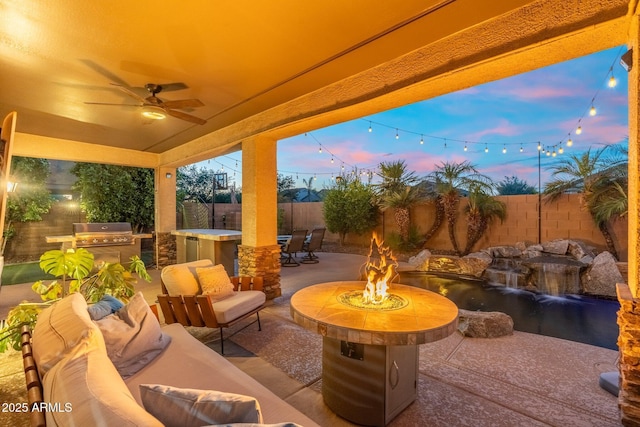 4960 E Colonial Dr, Chandler, AZ 85249 - patio terrace at dusk with a patio area, an outdoor living space with a fire pit, a fenced backyard, and ceiling fan