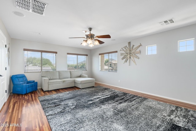 4960 E Colonial Dr, Chandler, AZ 85249 - living room featuring healthy amount of natural light, a ceiling fan, wood finished floors, and baseboards