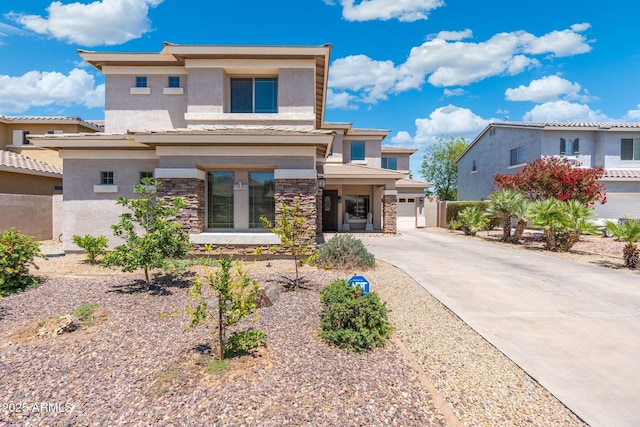 4960 E Colonial Dr, Chandler, AZ 85249 - prairie-style house featuring stucco siding, stone siding, concrete driveway, and a garage