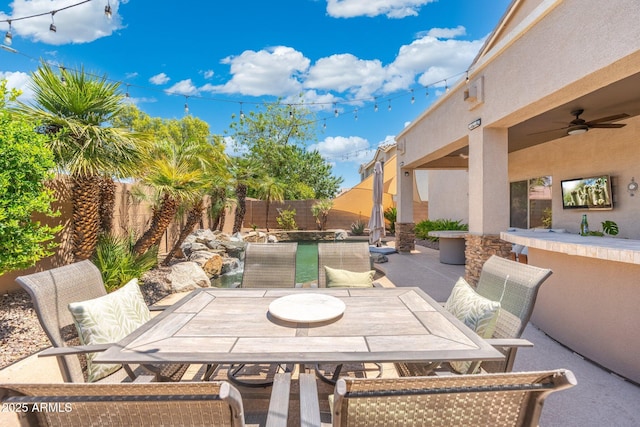 4960 E Colonial Dr, Chandler, AZ 85249 - fenced backyard featuring a ceiling fan, outdoor dining area, and a patio area
