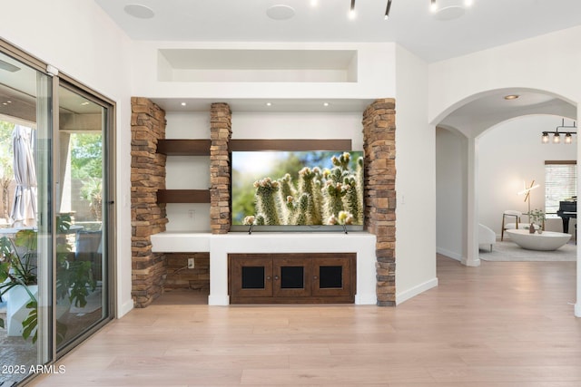 4960 E Colonial Dr, Chandler, AZ 85249 - unfurnished living room with arched walkways and wood finished floors