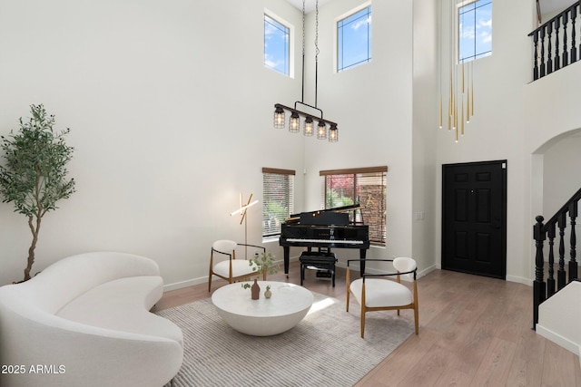 4960 E Colonial Dr, Chandler, AZ 85249 - entryway featuring a towering ceiling, stairs, light wood finished floors, baseboards, and arched walkways