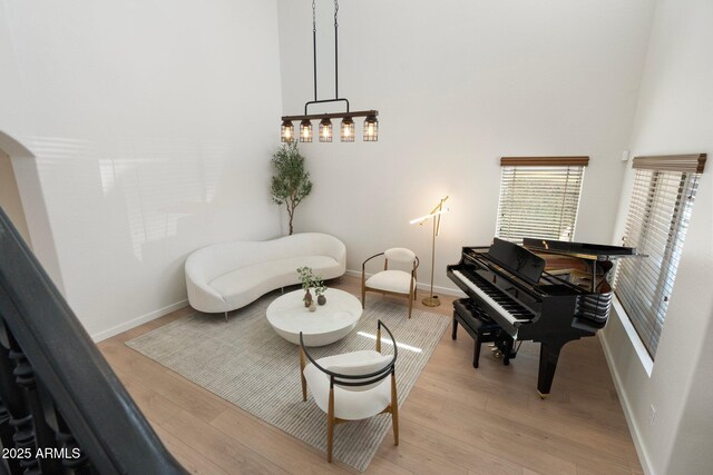 4960 E Colonial Dr, Chandler, AZ 85249 - sitting room with wood finished floors, baseboards, and a towering ceiling