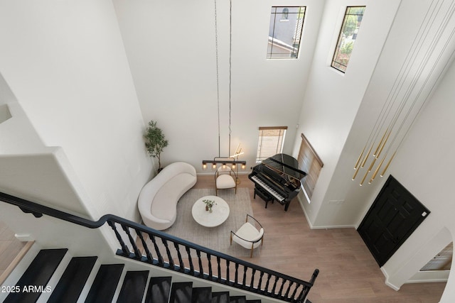 4960 E Colonial Dr, Chandler, AZ 85249 - staircase with wood finished floors, a towering ceiling, and baseboards