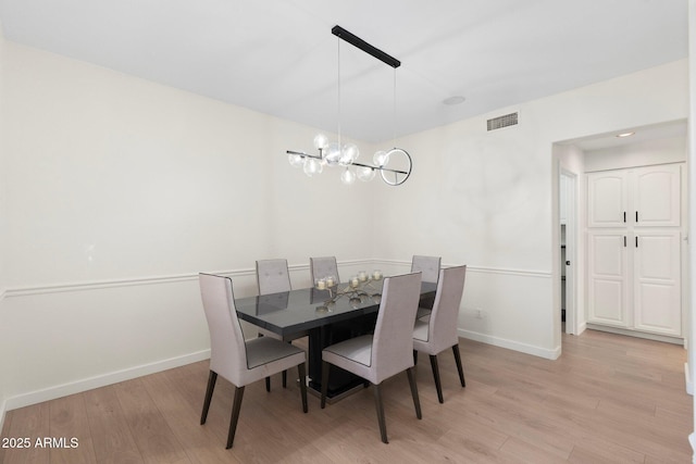 4960 E Colonial Dr, Chandler, AZ 85249 - dining space featuring light wood-style floors, baseboards, and a chandelier