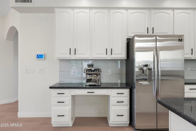 4960 E Colonial Dr, Chandler, AZ 85249 - kitchen with stainless steel refrigerator with ice dispenser, dark stone countertops, light wood finished floors, and white cabinetry