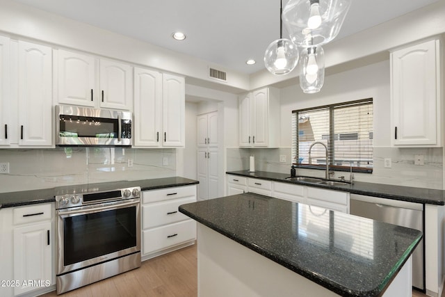 4960 E Colonial Dr, Chandler, AZ 85249 - kitchen with a sink, appliances with stainless steel finishes, backsplash, recessed lighting, and white cabinets