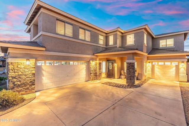 4960 E Colonial Dr, Chandler, AZ 85249 - view of front of home with an attached garage, driveway, stone siding, stucco siding, and a tile roof