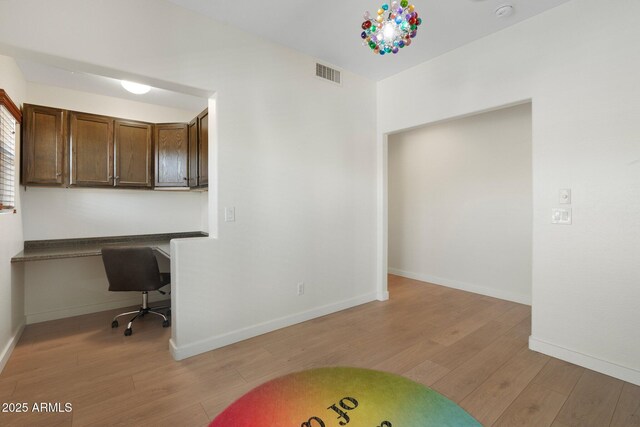 4960 E Colonial Dr, Chandler, AZ 85249 - unfurnished office featuring light wood-style floors, built in desk, and baseboards