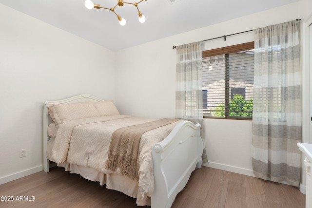 4960 E Colonial Dr, Chandler, AZ 85249 - bedroom featuring a chandelier, baseboards, and wood finished floors