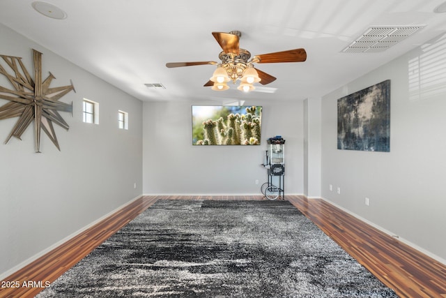 4960 E Colonial Dr, Chandler, AZ 85249 - unfurnished room featuring wood finished floors, a ceiling fan, and baseboards