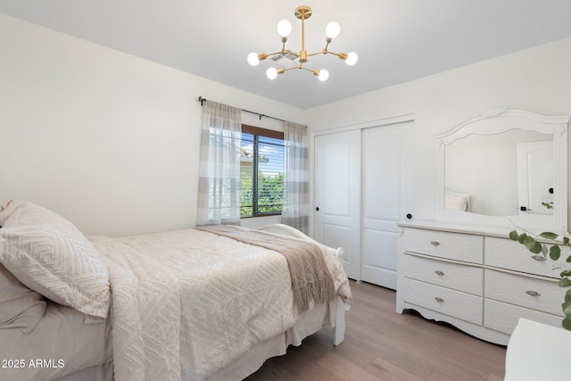 4960 E Colonial Dr, Chandler, AZ 85249 - bedroom featuring a chandelier, a closet, and light wood-type flooring