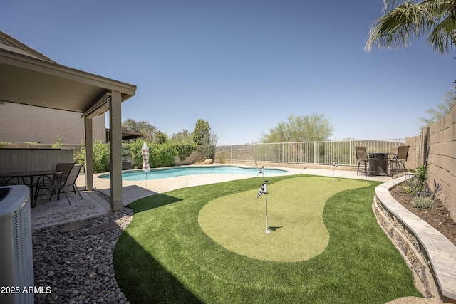 29110 N 24th Ln, Phoenix, AZ 85085 - fenced backyard featuring an area to practice putting, a patio area, central AC, and outdoor dining space