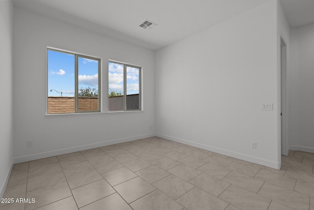 21541 W Mariposa St, Buckeye, AZ 85396 - empty room featuring baseboards and light tile patterned flooring