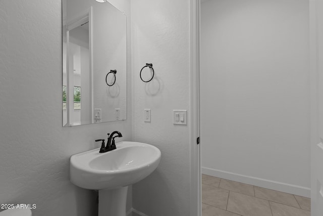21541 W Mariposa St, Buckeye, AZ 85396 - bathroom with tile patterned floors, a textured wall, and baseboards