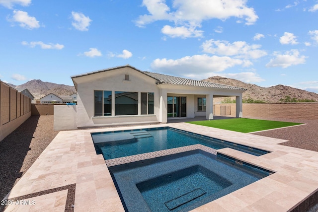 21541 W Mariposa St, Buckeye, AZ 85396 - rear view of house featuring a mountain view, stucco siding, an in-ground hot tub, and a patio