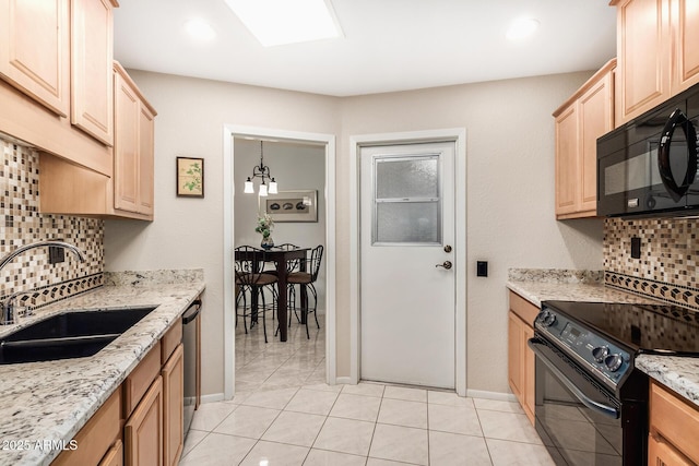 kitchen with tasteful backsplash, light stone counters, light brown cabinetry, black appliances, and a sink