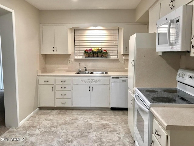 kitchen with sink, white cabinets, and white appliances