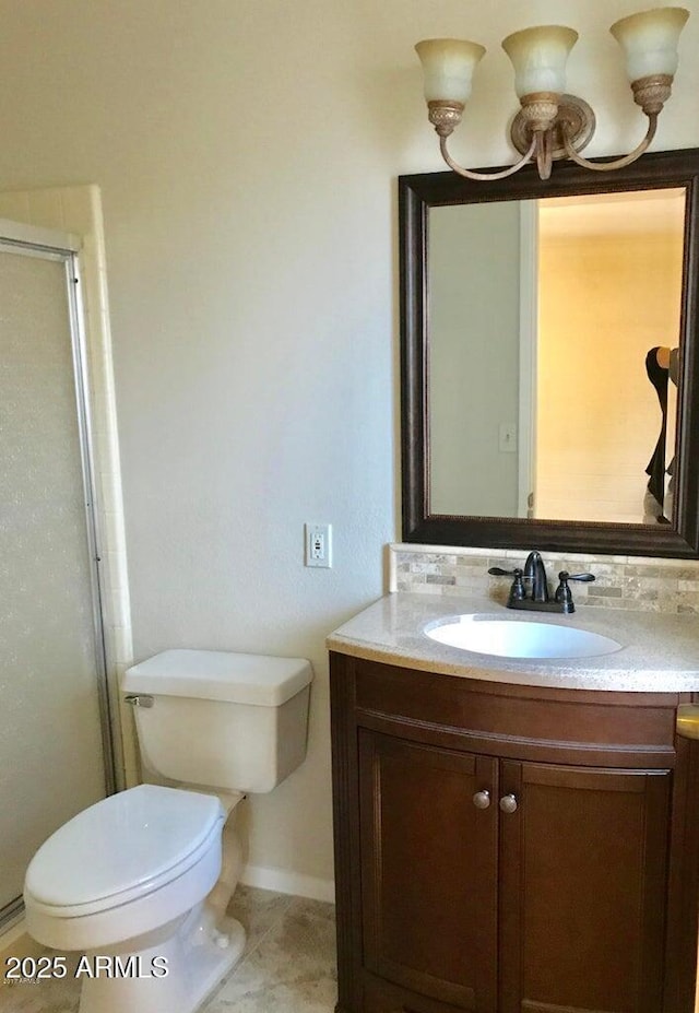 bathroom featuring tile patterned floors, vanity, toilet, and walk in shower