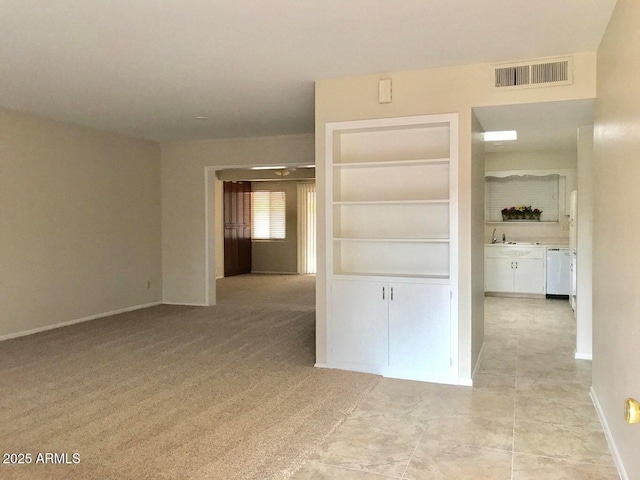 interior space featuring sink, built in features, and light carpet