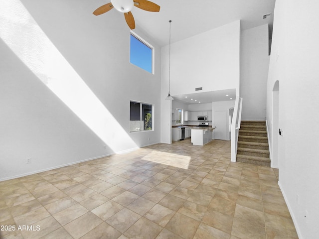 unfurnished living room featuring ceiling fan