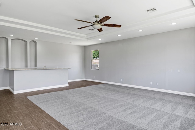 24615 S 182nd Pl, Gilbert, AZ 85298 - empty room featuring a raised ceiling, a ceiling fan, recessed lighting, and dark wood-type flooring