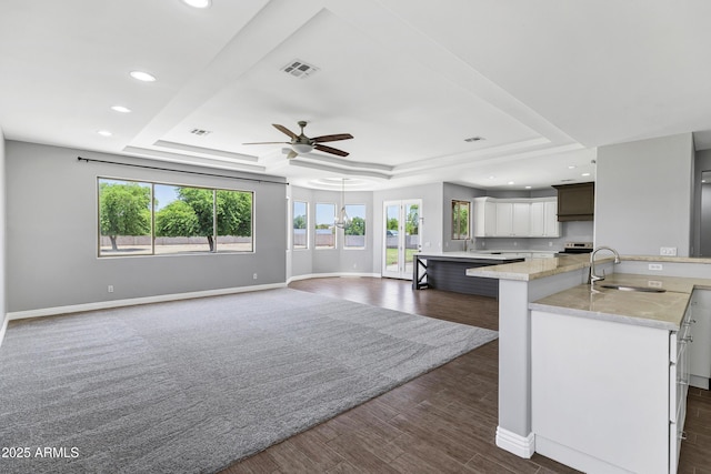 24615 S 182nd Pl, Gilbert, AZ 85298 - kitchen with a tray ceiling, ceiling fan, recessed lighting, dark wood-style floors, and a large island with sink