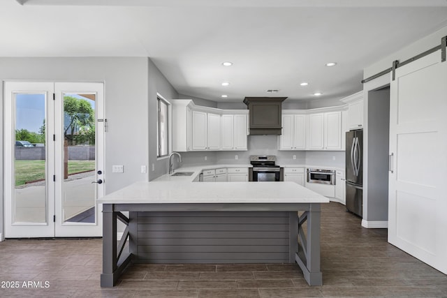 24615 S 182nd Pl, Gilbert, AZ 85298 - kitchen featuring stainless steel appliances, a peninsula, premium range hood, dark wood-style flooring, and recessed lighting