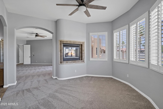 24615 S 182nd Pl, Gilbert, AZ 85298 - carpeted empty room featuring a ceiling fan, a multi sided fireplace, and arched walkways