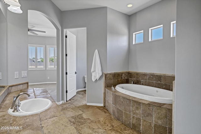 24615 S 182nd Pl, Gilbert, AZ 85298 - bathroom featuring a garden tub, a ceiling fan, plenty of natural light, and stone tile floors