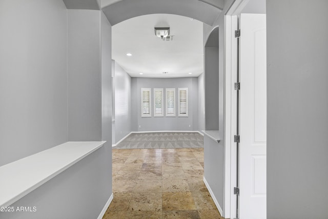 24615 S 182nd Pl, Gilbert, AZ 85298 - corridor featuring stone finish floors, arched walkways, and recessed lighting