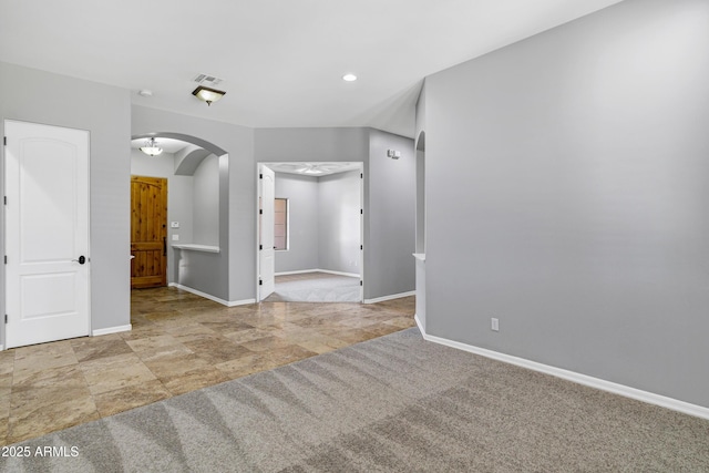 24615 S 182nd Pl, Gilbert, AZ 85298 - unfurnished room with arched walkways, stone finish floors, and recessed lighting