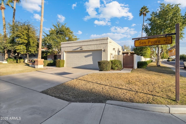8405 E San Pedro Dr, Scottsdale, AZ 85258 - view of side of property featuring an attached garage, concrete driveway, a gate, and stucco siding